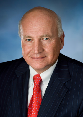 A man in a suit and tie with blue eyes.